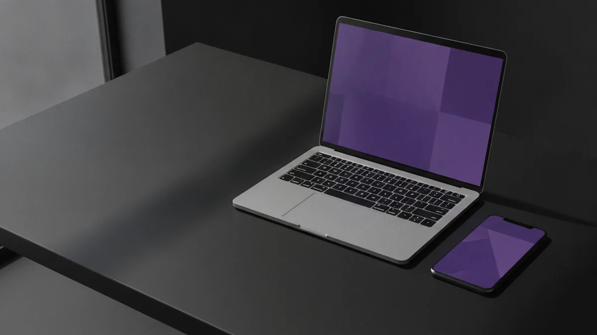 Laptop and phone on a desk while preparing a TikTok bio update.