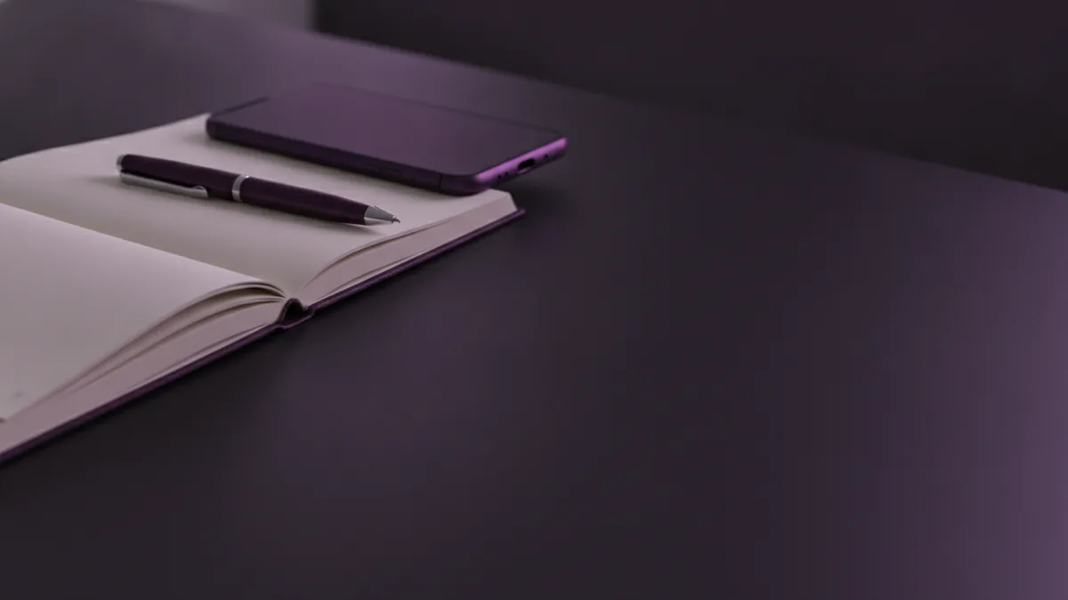 Improve your professional bio Phone beside a notebook with a polished professional social profile planning workspace