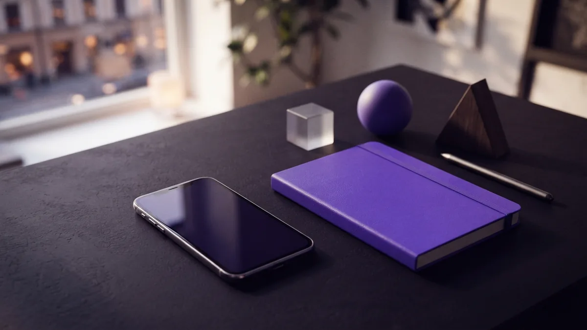 Find your social profile settings Mobile phone beside a profile planning notebook on a bright desk
