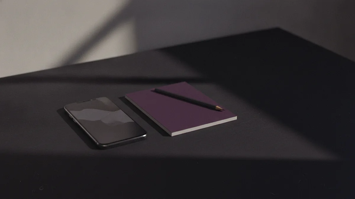 Notebook and phone ready for updating an Instagram bio